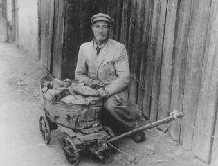 An impoverished ghetto resident sells bread on the black market. Kovno, Lithuania, between 1941 and 1943